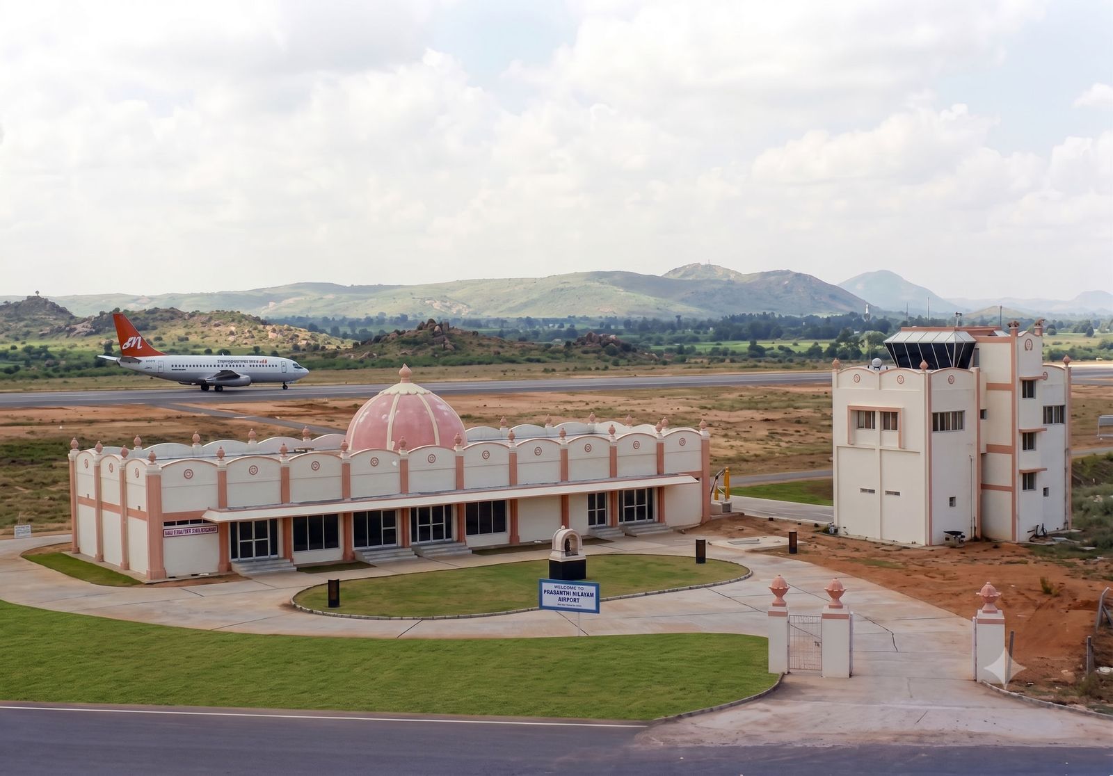 Prasanthi Nilayam Airport — the domed terminal and control tower with an aircraft on the runway